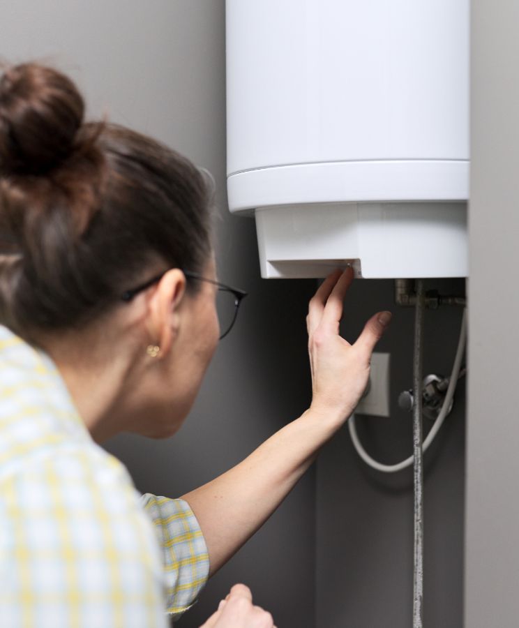 Woman Switching On The Heater